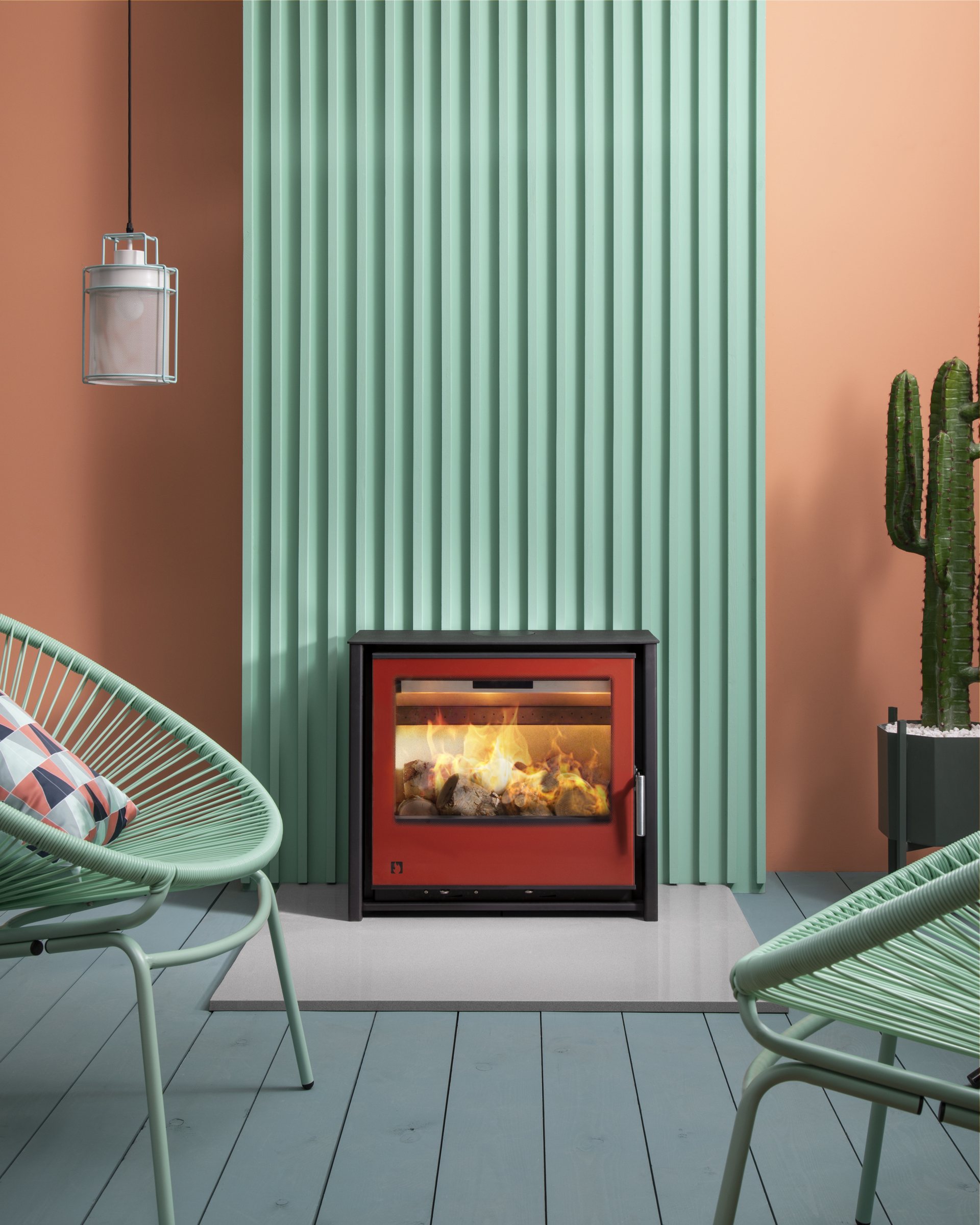 Arada i600 Slimline Freestanding Low stove in Spice red in stylish contemporary pastel-coloured room
